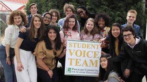 Members of the Student Voice Team pose with a sign